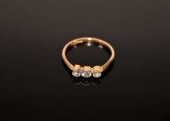 An 18ct gold three stone diamond ring, size M.