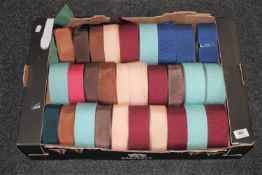 A box of spools of vintage hat trim