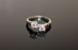 An antique two stone diamond ring in 18ct white gold, each stone approximately 0.35ct.