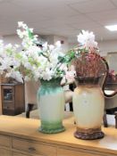 Two large pottery vases with artificial flowers