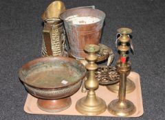 A tray of brass and copper including embossed jugs, trivet,