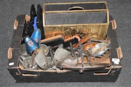 A box containing wooden hand brushes, shoe stretchers, pewter tankards,