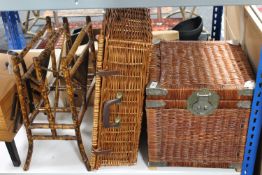 Two wicker storage baskets together with an antique bamboo magazine rack