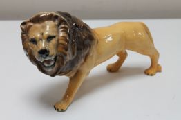 A Beswick china figure - Lion, facing left, height 14 cm,