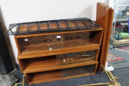 A mid 20th century three part floating bookcase with glazed sliding doors
