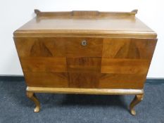 An early 20th century mahogany and oak fall front cabinet