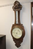 A carved oak aneroid barometer