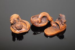 Three well carved Japanese boxwood netsuke depicting a rat on a mushroom,