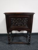 A carved oak antique style fall front cabinet