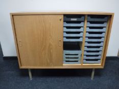 A pair of mid 20th century teak sliding door office cabinets