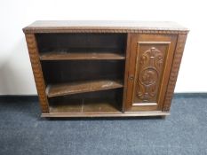 An early 20th century carved oak bookcase