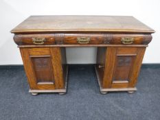 A late Victorian oak pedestal desk