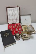 A silver sauceboat, two silver napkin rings, two spoons, a boxed set of six plated dessert forks,