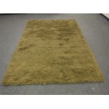 A hand knotted heavy quality green shaggy piled carpet RRP £681.00.