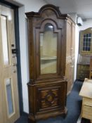 A continental glazed walnut corner cabinet