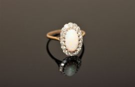 An opal and diamond cluster ring, a large cabochon opal within a border of old cut diamonds,