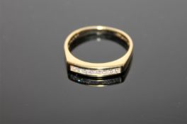 An 18ct gold ring, channel set with eight princess cut diamonds, size O, 3g.