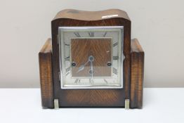 An Art Deco oak cased eight day mantel clock with silvered dial
