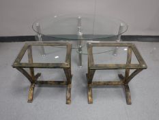 A pair of heavy quality metal based glass topped lamp tables together with a three tier