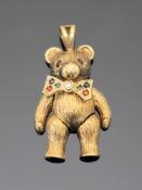 A gold pendant modelled as a bear, set with rubies, emeralds, sapphires and a central diamond,