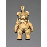 A gold pendant modelled as a bear, set with rubies, emeralds, sapphires and a central diamond,