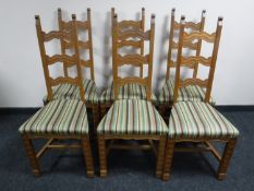 A set of six carved oak dining chairs with stripped fabric seats