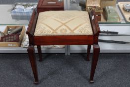 A mahogany piano stool