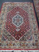 A fringed Tabriz style rug