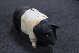 A painted metal pig money bank