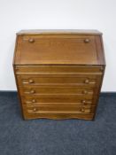 An oak bureau fitted four drawers