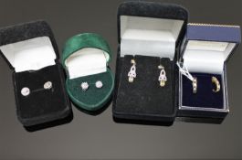 Three pairs of gold earrings and a pair of silver earrings