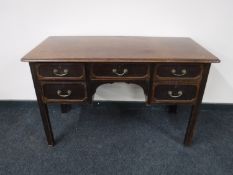 An early 20th century Georgian style five drawer mahogany desk