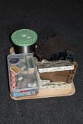 A tray containing fishing spools, reel,