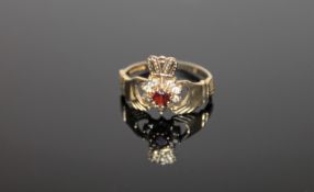 A 9ct gold garnet set Claddagh ring