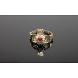 A 9ct gold garnet set Claddagh ring