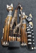 A collection of cat ornaments, wooden figures,