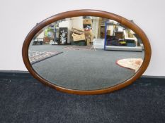 An Edwardian mahogany oval framed mirror