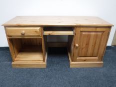 A contemporary pine pedestal desk