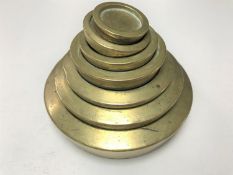 A set of seven 19th century brass sovereign weights