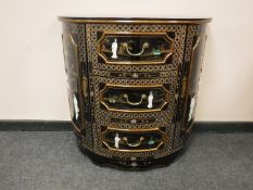 A Japanese lacquered D shaped side cabinet fitted three drawers with mother of pearl figures