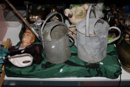 Two galvanised watering cans, pottery bust of James Dean,