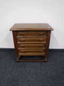 An oak four drawer chest