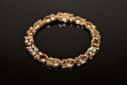 A 9ct gold bracelet set with amethyst, citrine, topaz, peridot etc, 19.9g.