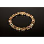 A 9ct gold bracelet set with amethyst, citrine, topaz, peridot etc, 19.9g.