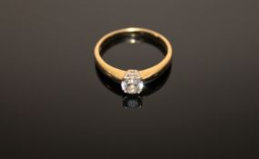 An 18ct gold solitaire diamond ring, the brilliant cut stone weighing an estimated 0.