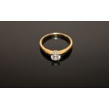 An 18ct gold solitaire diamond ring, the brilliant cut stone weighing an estimated 0.