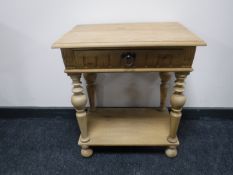 An antique style pine side table fitted a drawer