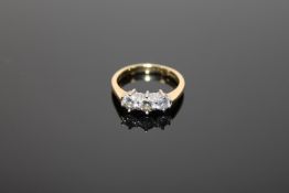 An 18ct gold three stone diamond ring,