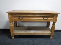A rustic pine serving table fitted a drawer