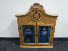 A continental oak glazed cabinet with clock